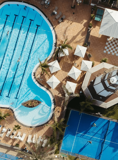 Aerial view of Hotel Fariones Lanzarote outdoor pool and tennis court, luxury hotel Puerto del Carme