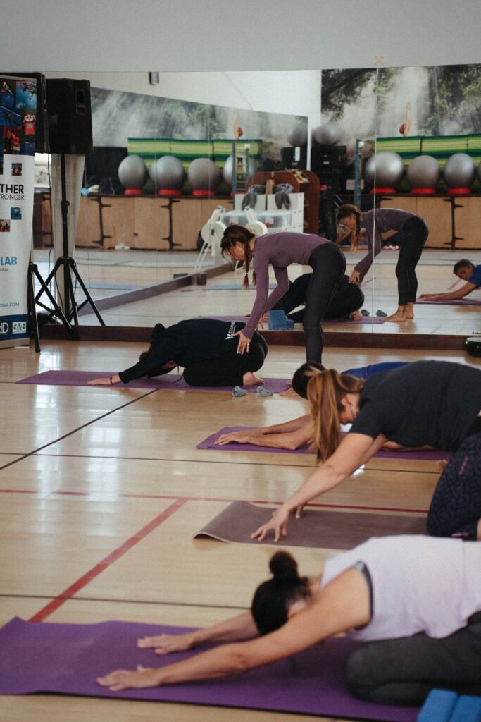 Yoga class with instructor assisting guests at luxury Hotel Fariones Lanzarote wellness facilities