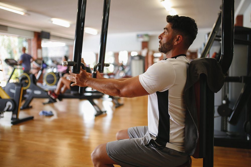 Man using weight machine at the fitness center of luxury hotel Lanzarote Hotel Fariones