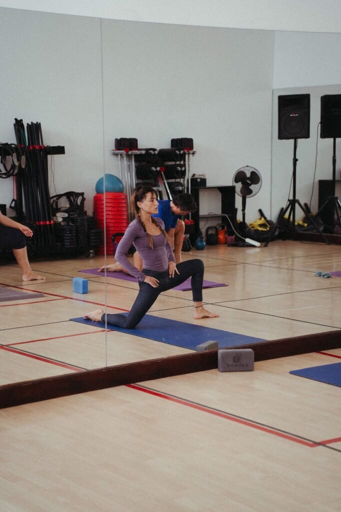 Yoga class with guests on blue mats at luxury hotel Lanzarote Fariones fitness studio